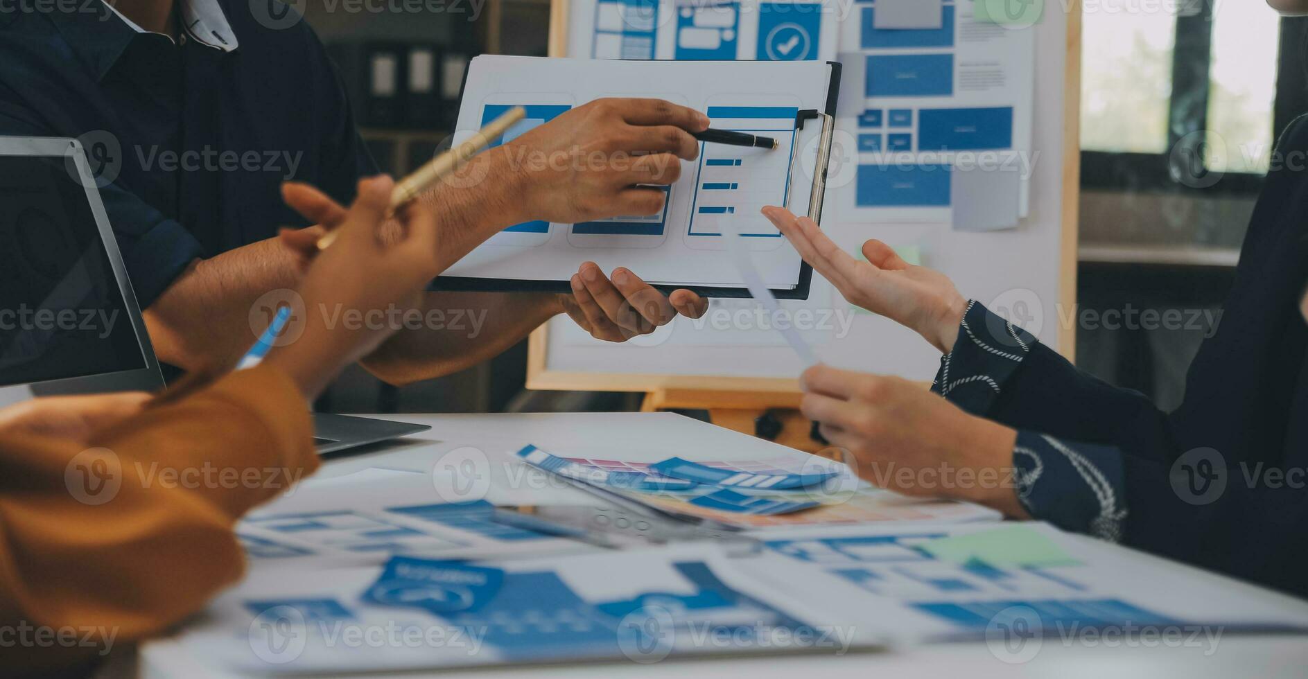 Close up ux developer and ui designer use augmented reality brainstorming about mobile app interface wireframe design on desk at modern office.Creative digital development agency photo