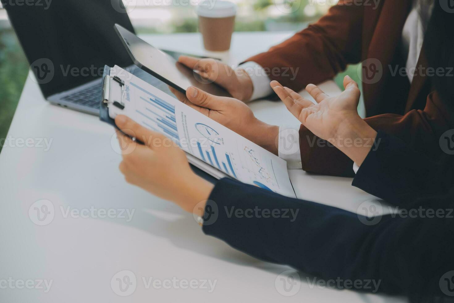 Financial analysts analyze business financial reports on a digital tablet planning investment project during a discussion at a meeting of corporate showing the results of their successful teamwork. photo