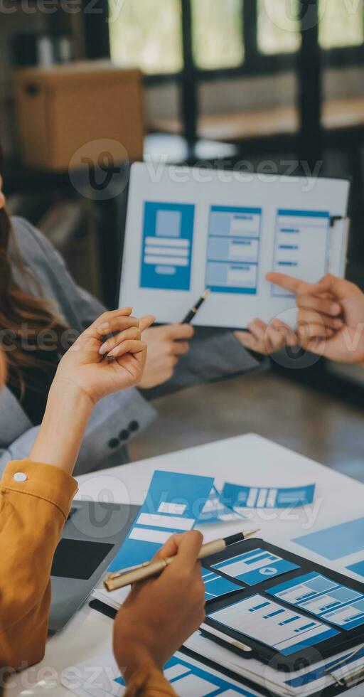 Close up ux developer and ui designer use augmented reality brainstorming about mobile app interface wireframe design on desk at modern office.Creative digital development agency photo