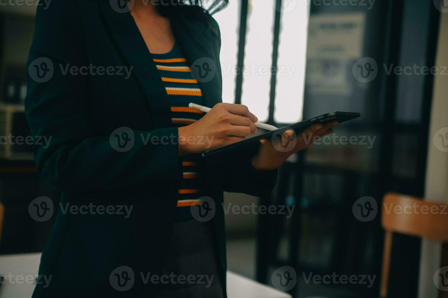 Charming Young asian businesswoman sitting on laptop computer in the office, making report calculating balance Internal Revenue Service checking document. photo
