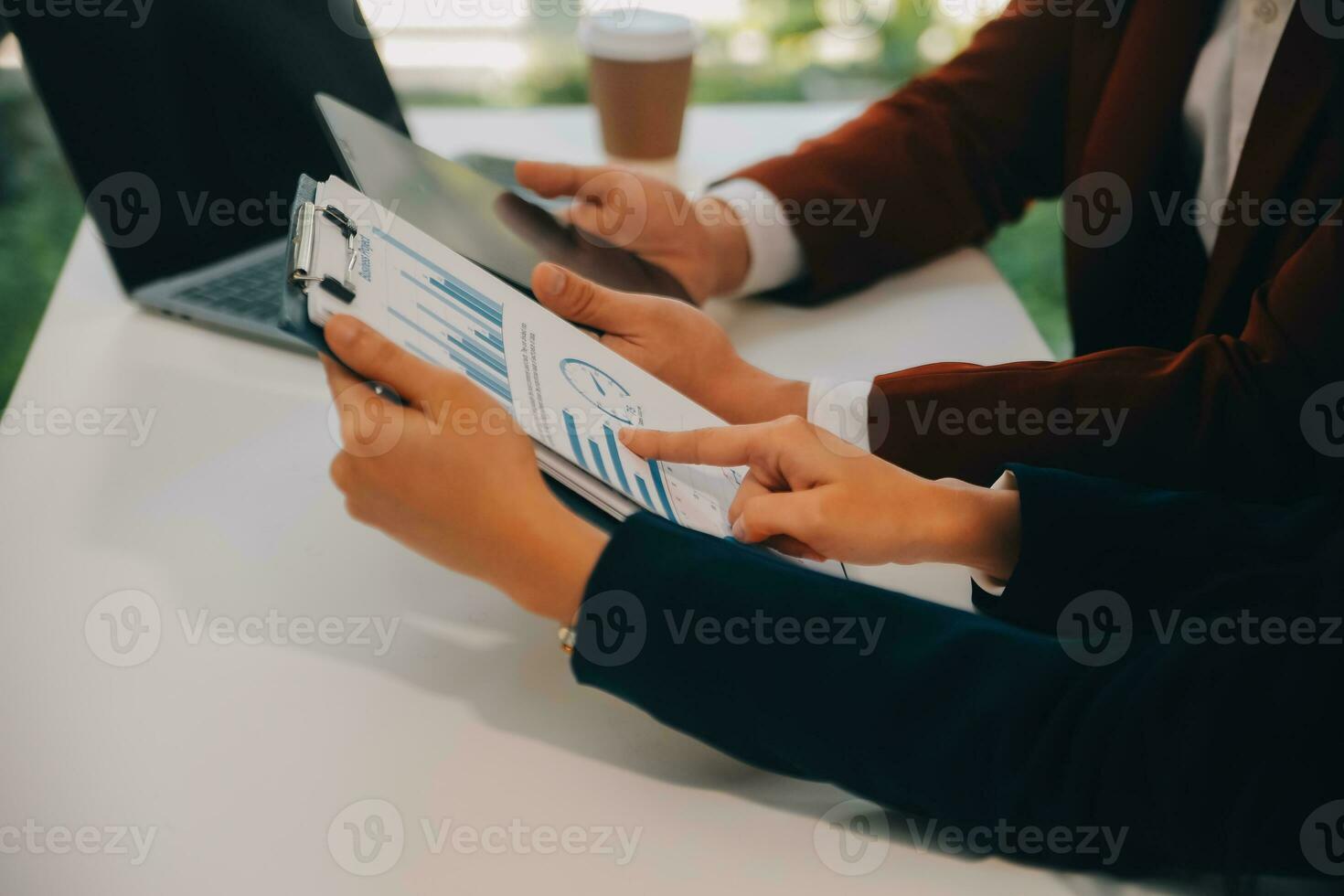 Financial analysts analyze business financial reports on a digital tablet planning investment project during a discussion at a meeting of corporate showing the results of their successful teamwork. photo