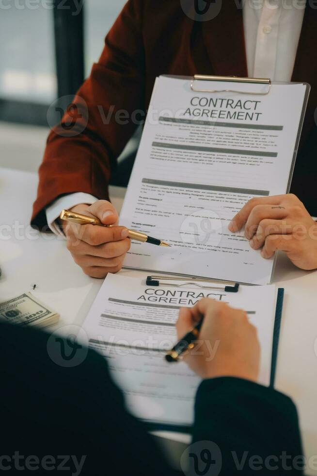Lawyer, legal advisor, businessman brainstorming information on agreement details Business contracts in legal processing books for accuracy in contract documents. joint financial investment. photo