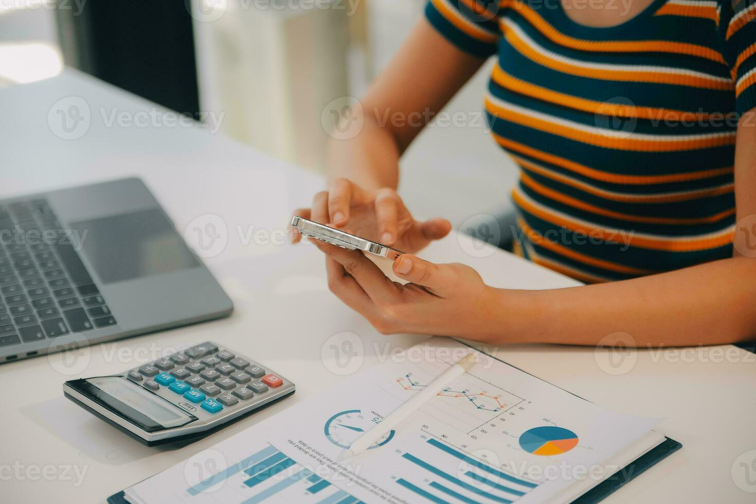 Charming Young asian businesswoman sitting on laptop computer in the office, making report calculating balance Internal Revenue Service checking document. photo