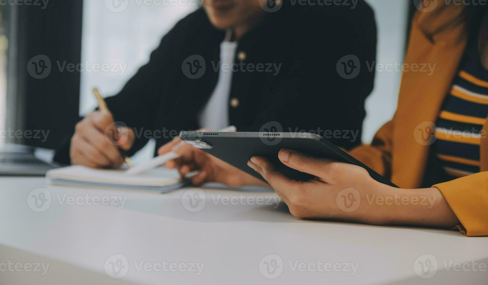 Charming Young asian businesswoman sitting on laptop computer in the office, making report calculating balance Internal Revenue Service checking document. photo