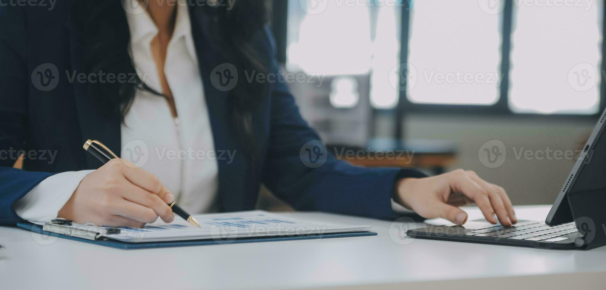 Financial analysts analyze business financial reports on a digital tablet planning investment project during a discussion at a meeting of corporate showing the results of their successful teamwork. photo