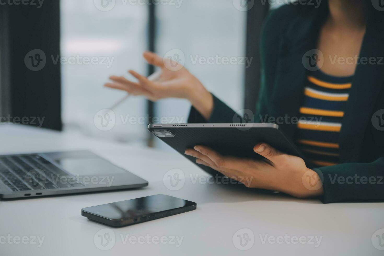 Charming Young asian businesswoman sitting on laptop computer in the office, making report calculating balance Internal Revenue Service checking document. photo
