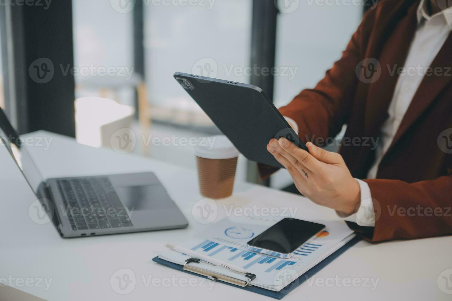 Financial analysts analyze business financial reports on a digital tablet planning investment project during a discussion at a meeting of corporate showing the results of their successful teamwork. photo