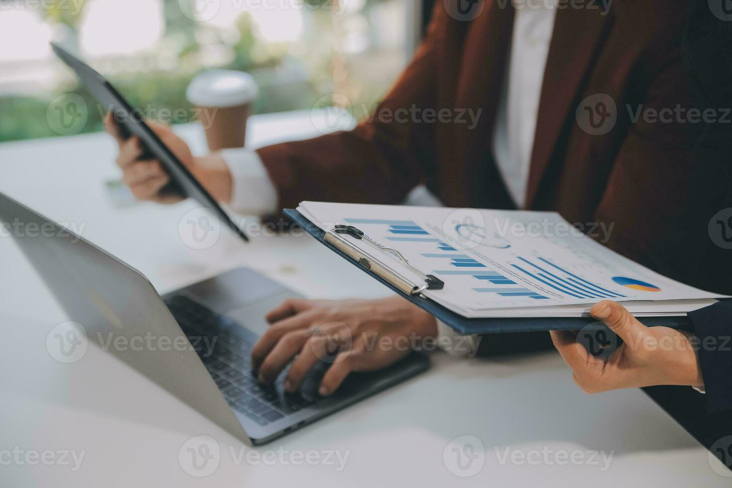 Financial analysts analyze business financial reports on a digital tablet planning investment project during a discussion at a meeting of corporate showing the results of their successful teamwork. photo