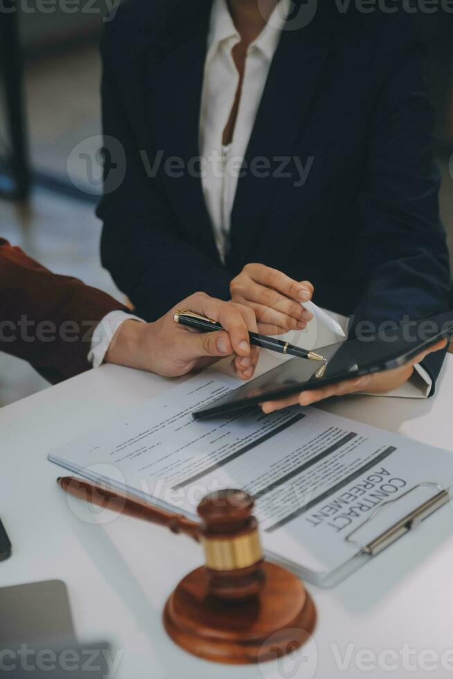 Lawyer, legal advisor, businessman brainstorming information on agreement details Business contracts in legal processing books for accuracy in contract documents. joint financial investment. photo