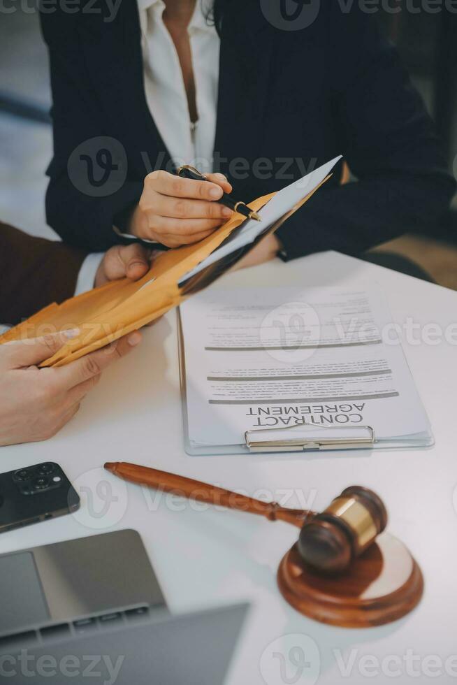 Lawyer, legal advisor, businessman brainstorming information on agreement details Business contracts in legal processing books for accuracy in contract documents. joint financial investment. photo