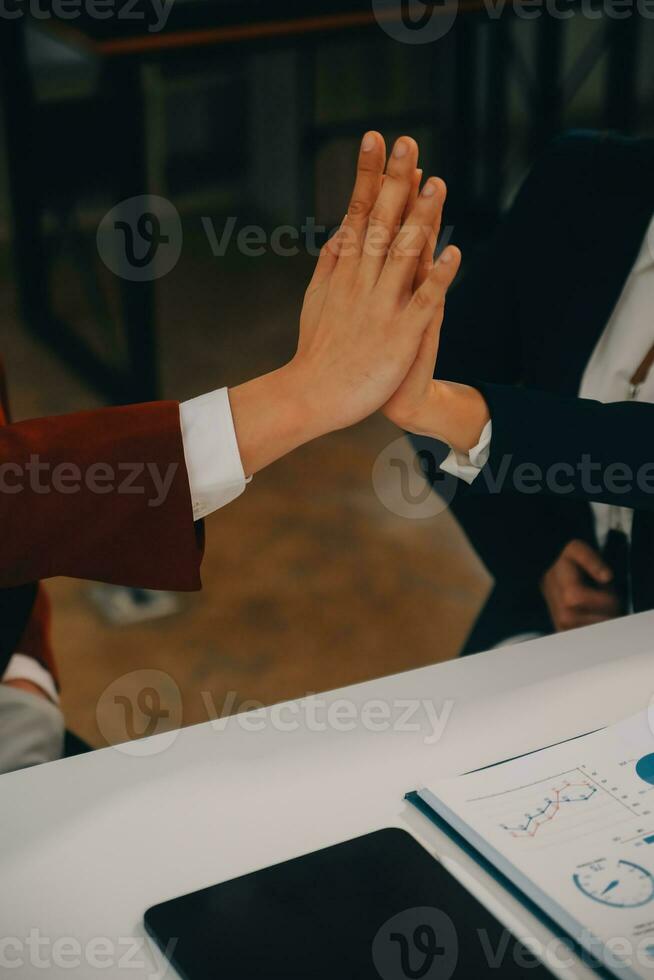 Financial analysts analyze business financial reports on a digital tablet planning investment project during a discussion at a meeting of corporate showing the results of their successful teamwork. photo