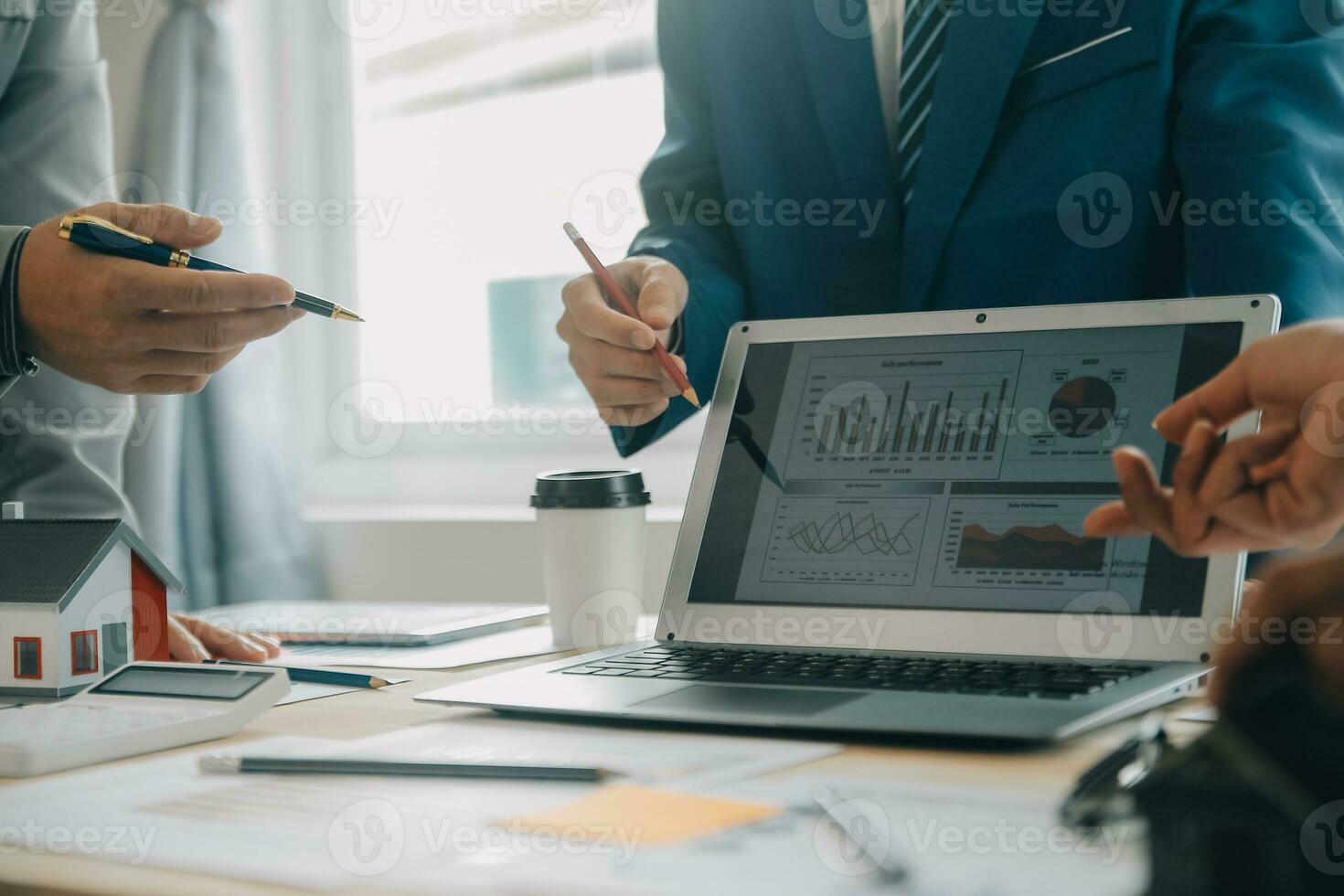 Financial analysts analyze business financial reports on a digital tablet planning investment project during a discussion at a meeting of corporate showing the results of their successful teamwork. photo