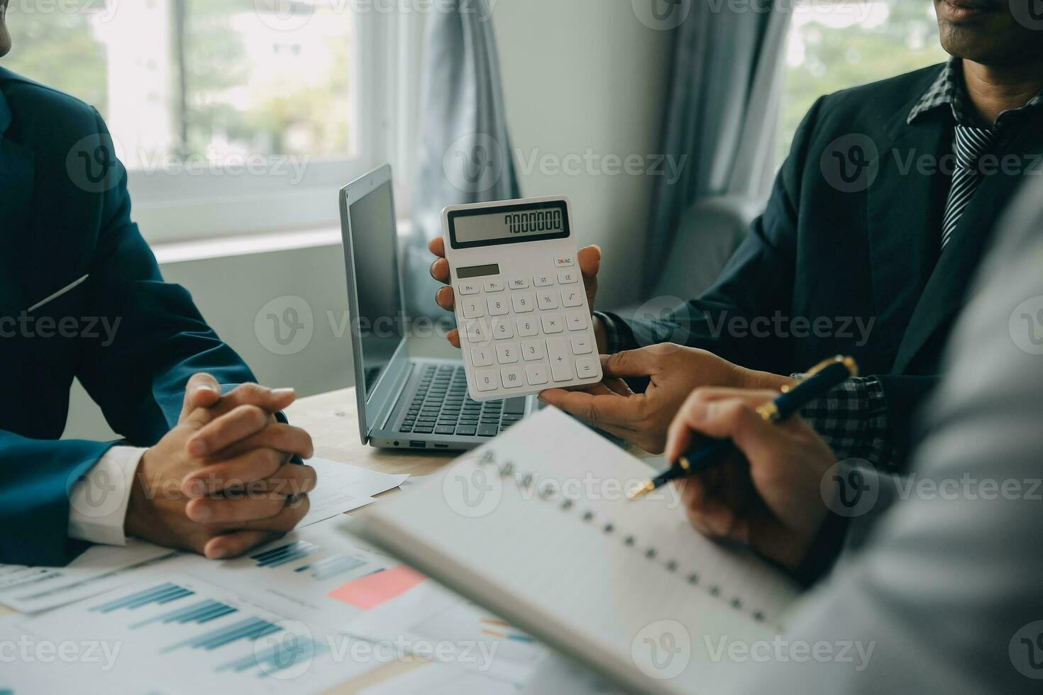 Financial analysts analyze business financial reports on a digital tablet planning investment project during a discussion at a meeting of corporate showing the results of their successful teamwork. photo
