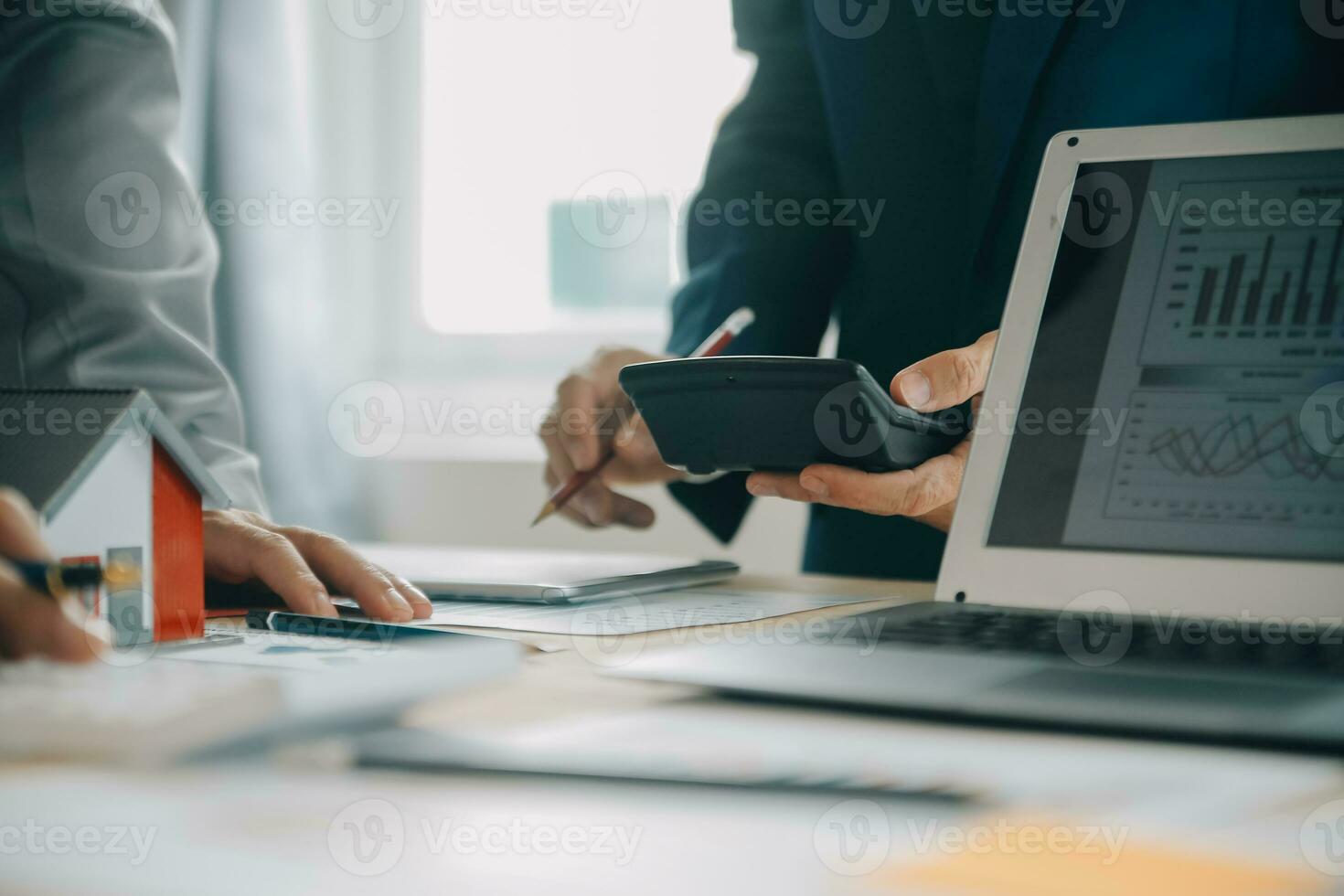 Financial analysts analyze business financial reports on a digital tablet planning investment project during a discussion at a meeting of corporate showing the results of their successful teamwork. photo