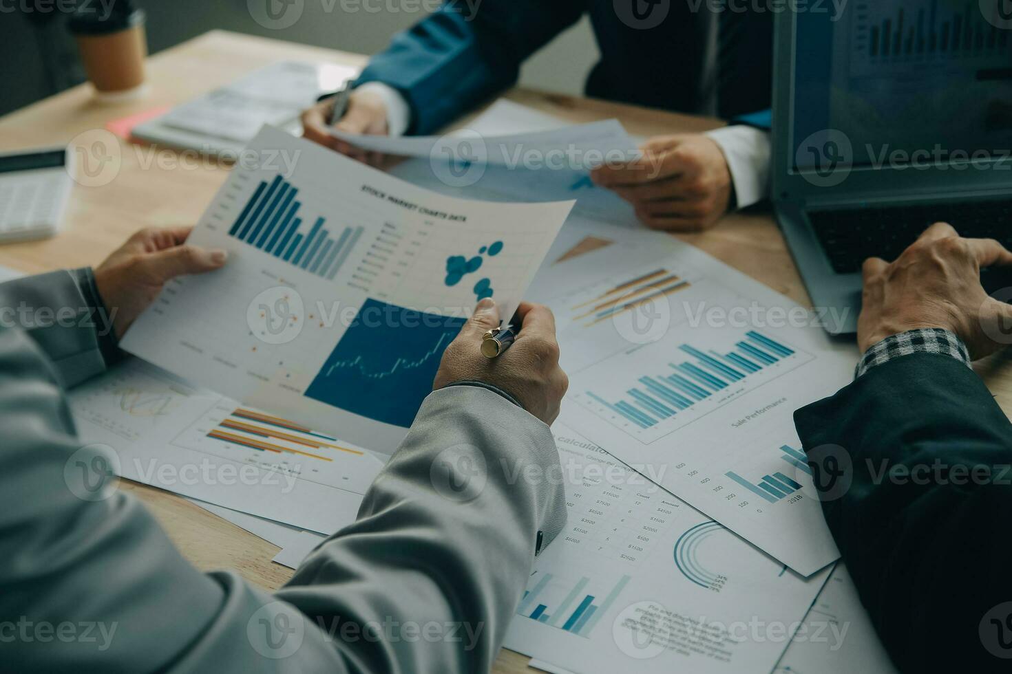 Financial analysts analyze business financial reports on a digital tablet planning investment project during a discussion at a meeting of corporate showing the results of their successful teamwork. photo