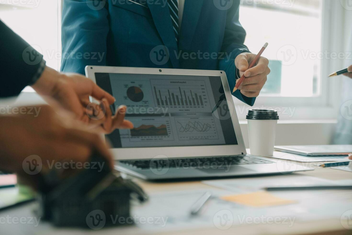 Financial analysts analyze business financial reports on a digital tablet planning investment project during a discussion at a meeting of corporate showing the results of their successful teamwork. photo