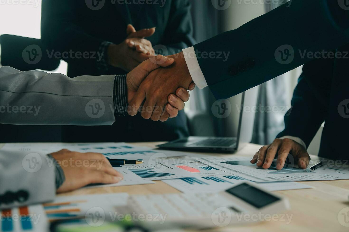 Financial analysts analyze business financial reports on a digital tablet planning investment project during a discussion at a meeting of corporate showing the results of their successful teamwork. photo