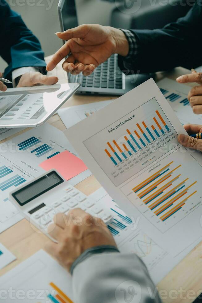 Financial analysts analyze business financial reports on a digital tablet planning investment project during a discussion at a meeting of corporate showing the results of their successful teamwork. photo