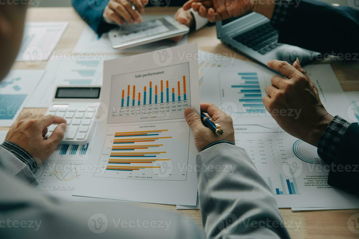 Financial analysts analyze business financial reports on a digital tablet planning investment project during a discussion at a meeting of corporate showing the results of their successful teamwork. photo