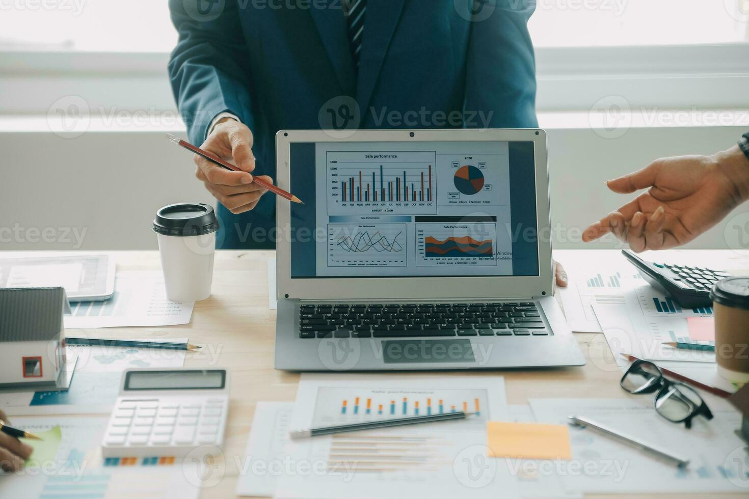 Financial analysts analyze business financial reports on a digital tablet planning investment project during a discussion at a meeting of corporate showing the results of their successful teamwork. photo
