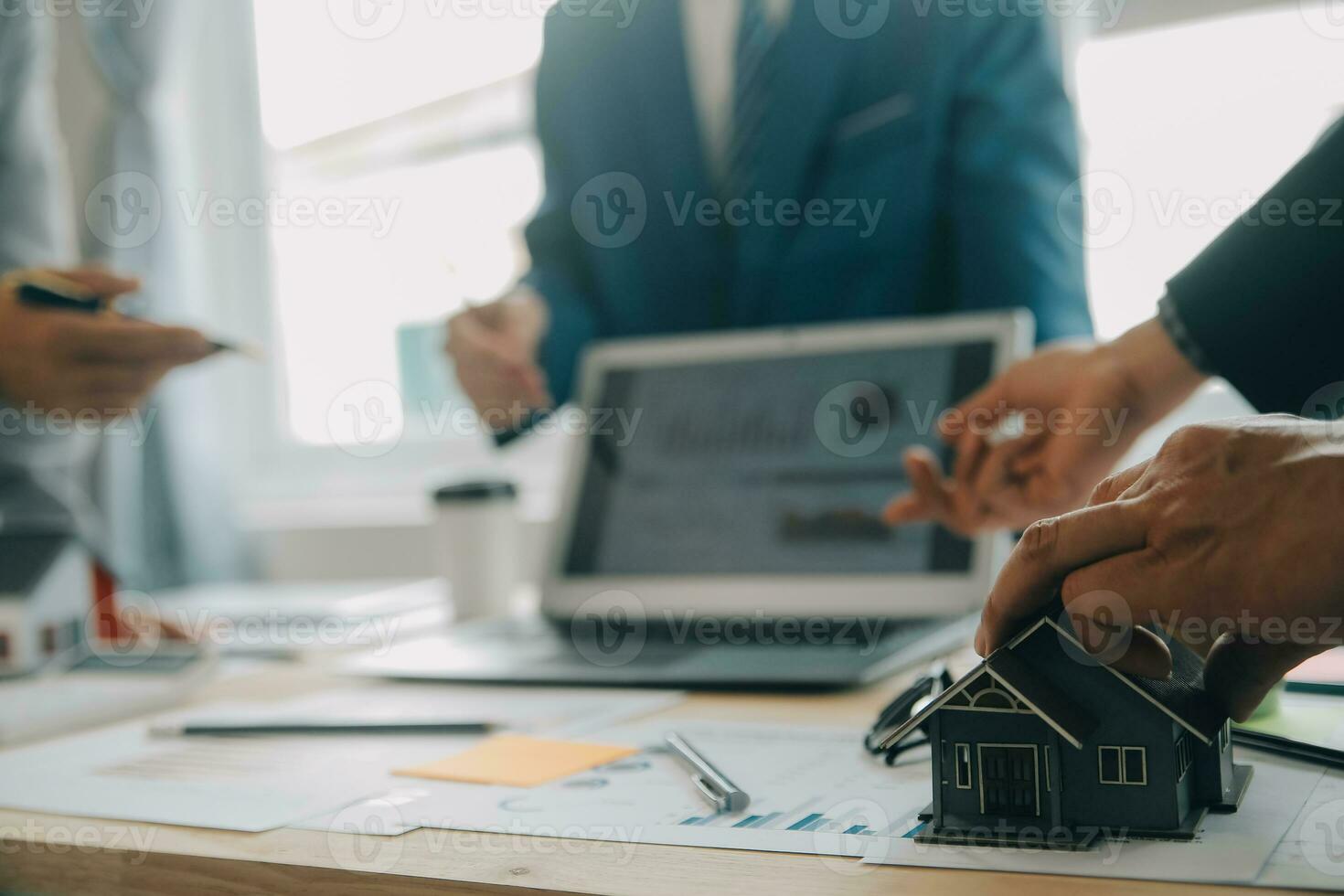 Financial analysts analyze business financial reports on a digital tablet planning investment project during a discussion at a meeting of corporate showing the results of their successful teamwork. photo