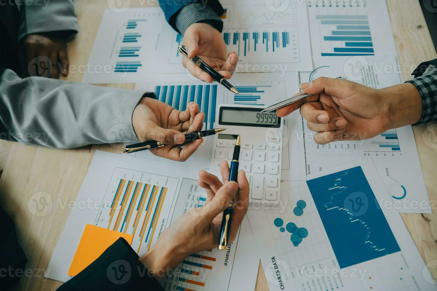 Financial analysts analyze business financial reports on a digital tablet planning investment project during a discussion at a meeting of corporate showing the results of their successful teamwork. photo