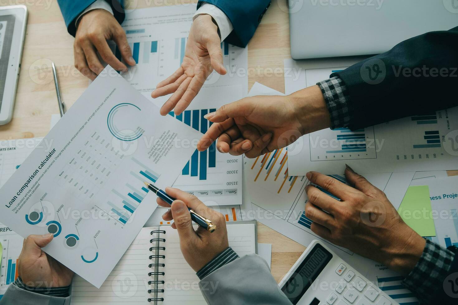 Financial analysts analyze business financial reports on a digital tablet planning investment project during a discussion at a meeting of corporate showing the results of their successful teamwork. photo