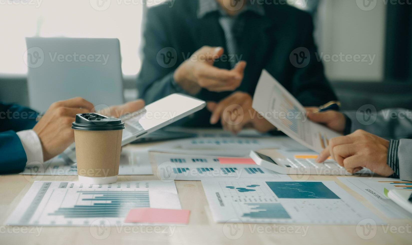 Financial analysts analyze business financial reports on a digital tablet planning investment project during a discussion at a meeting of corporate showing the results of their successful teamwork. photo