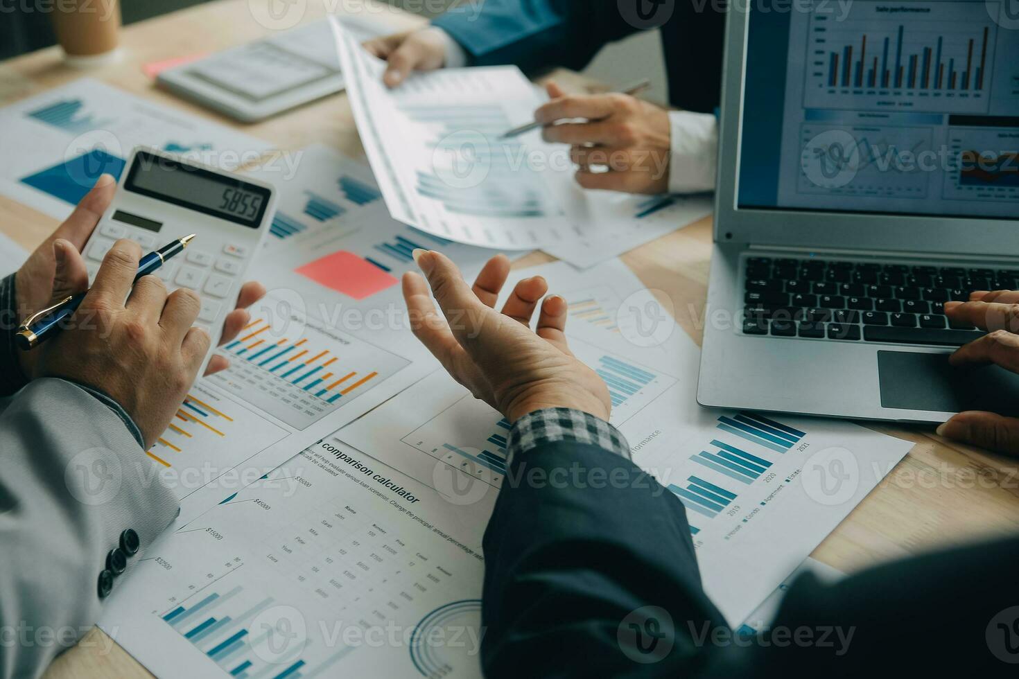 Financial analysts analyze business financial reports on a digital tablet planning investment project during a discussion at a meeting of corporate showing the results of their successful teamwork. photo