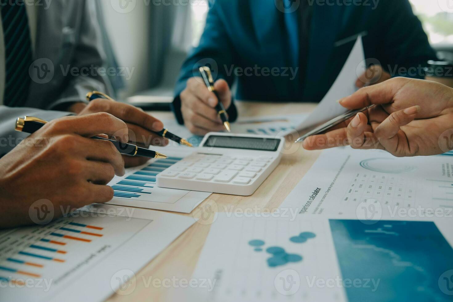 Financial analysts analyze business financial reports on a digital tablet planning investment project during a discussion at a meeting of corporate showing the results of their successful teamwork. photo