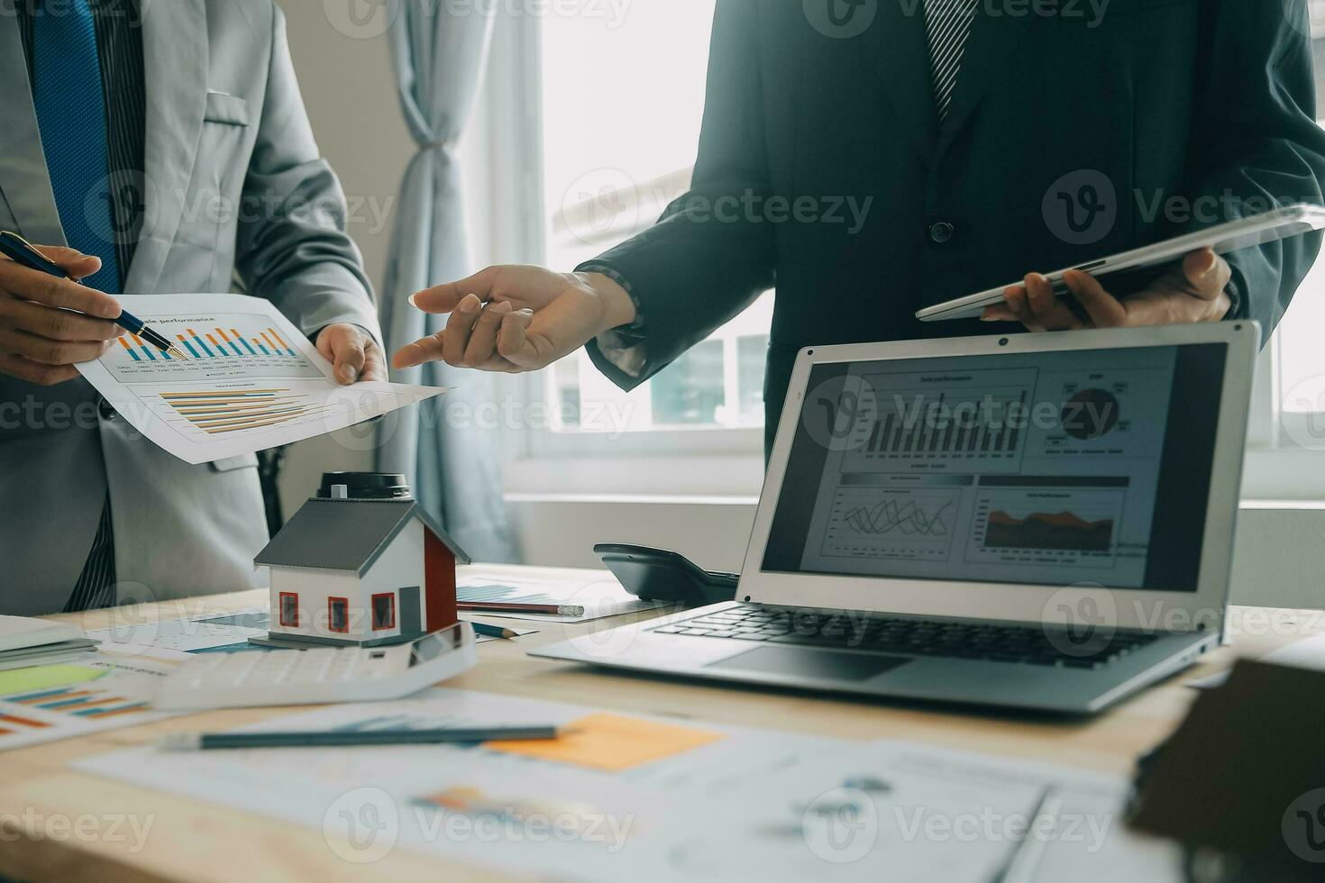 Financial analysts analyze business financial reports on a digital tablet planning investment project during a discussion at a meeting of corporate showing the results of their successful teamwork. photo