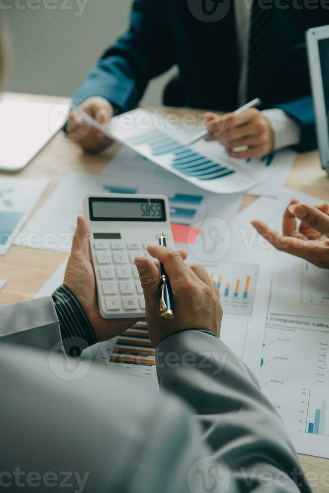 Financial analysts analyze business financial reports on a digital tablet planning investment project during a discussion at a meeting of corporate showing the results of their successful teamwork. photo