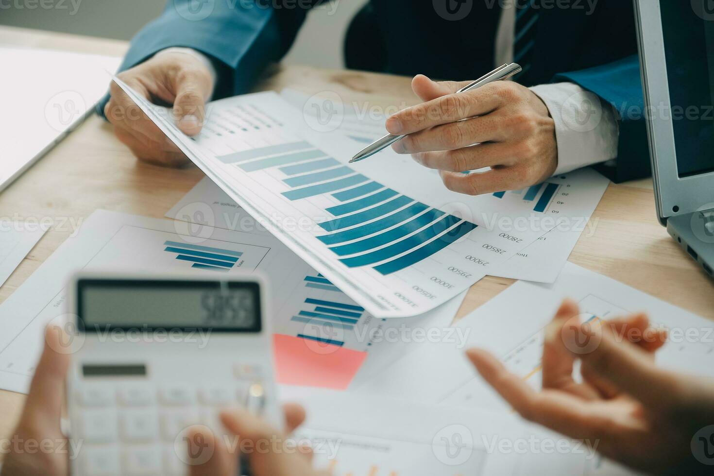 Financial analysts analyze business financial reports on a digital tablet planning investment project during a discussion at a meeting of corporate showing the results of their successful teamwork. photo