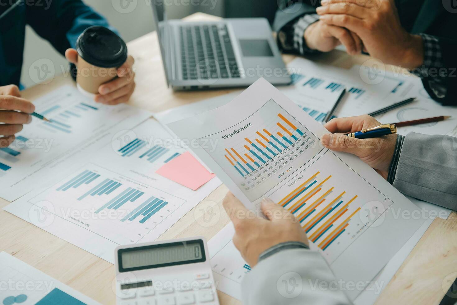 Financial analysts analyze business financial reports on a digital tablet planning investment project during a discussion at a meeting of corporate showing the results of their successful teamwork. photo