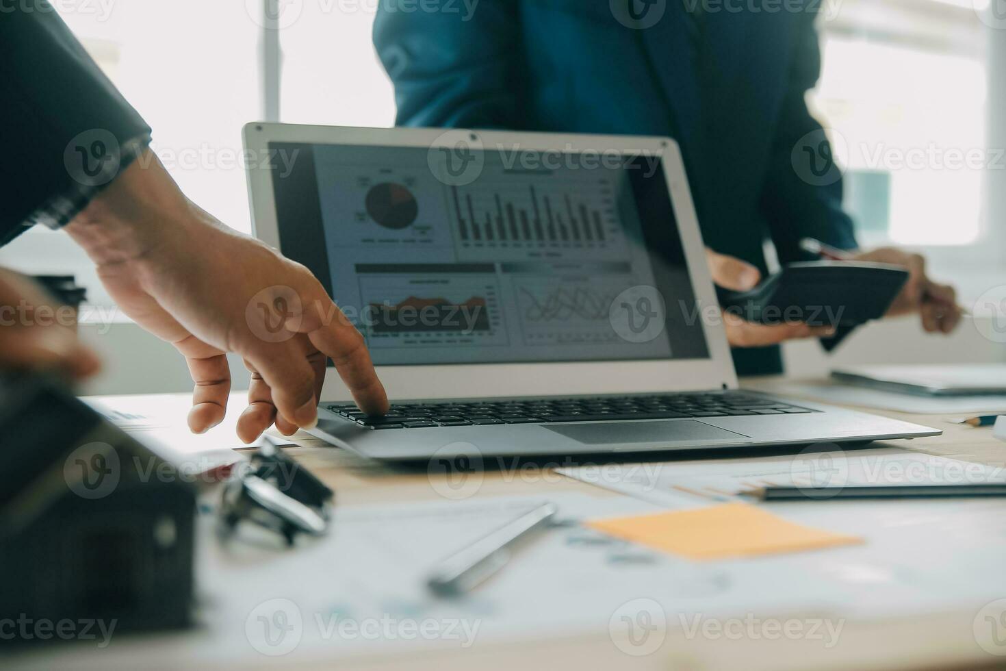 Financial analysts analyze business financial reports on a digital tablet planning investment project during a discussion at a meeting of corporate showing the results of their successful teamwork. photo