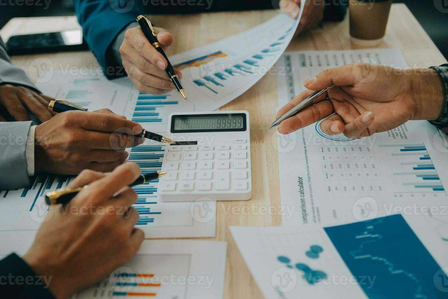 Financial analysts analyze business financial reports on a digital tablet planning investment project during a discussion at a meeting of corporate showing the results of their successful teamwork. photo