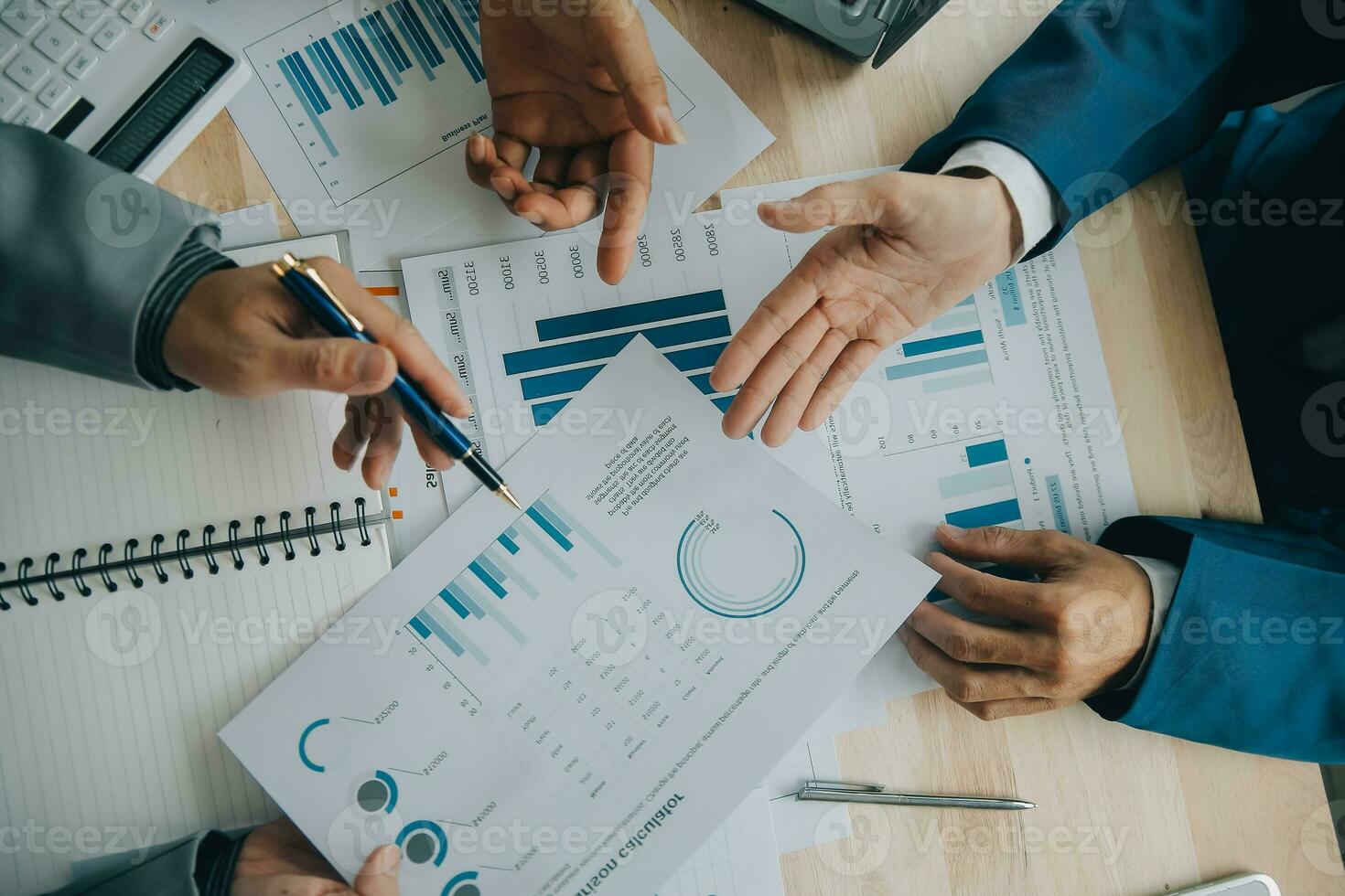Financial analysts analyze business financial reports on a digital tablet planning investment project during a discussion at a meeting of corporate showing the results of their successful teamwork. photo