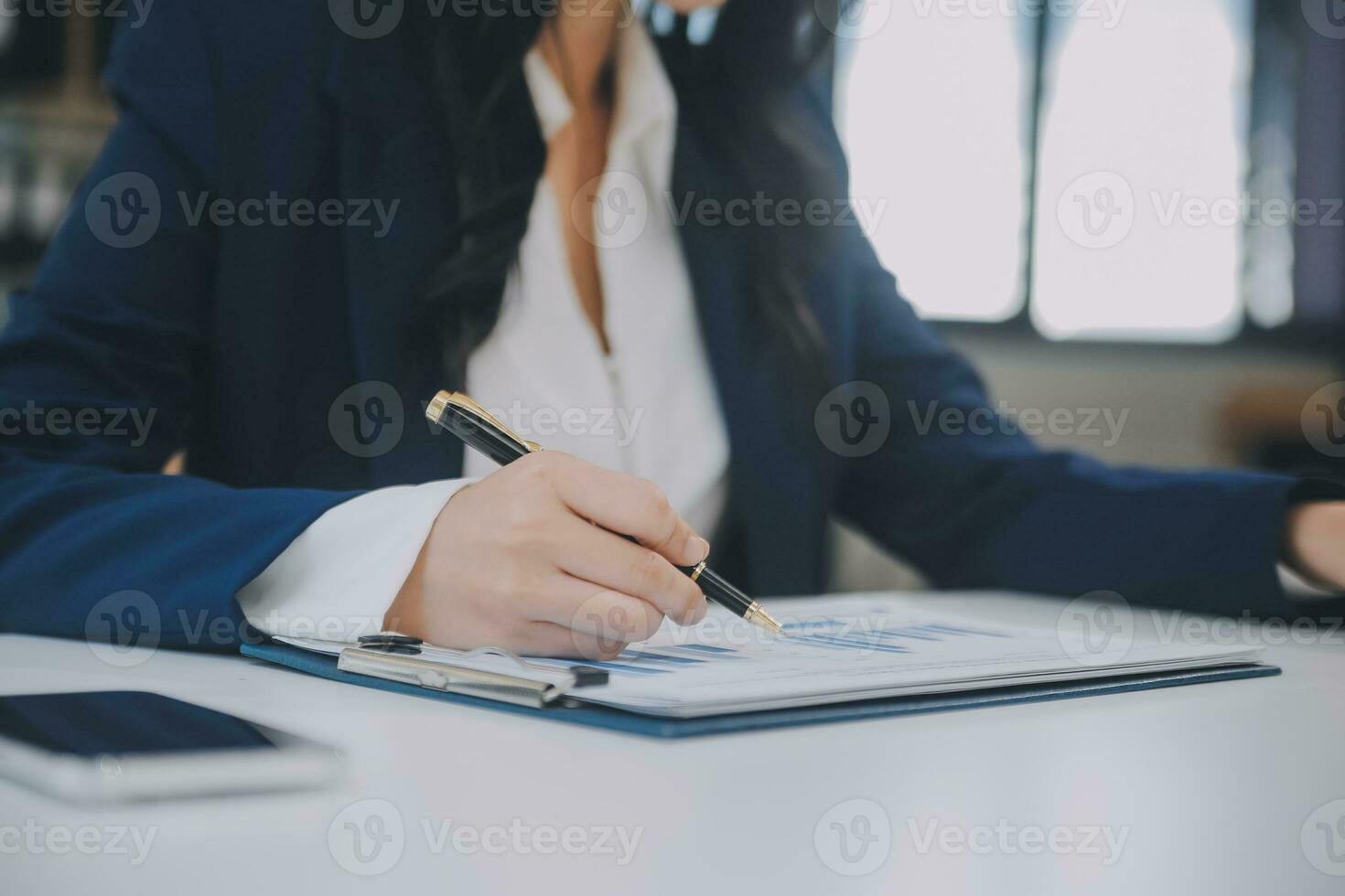 Financial analysts analyze business financial reports on a digital tablet planning investment project during a discussion at a meeting of corporate showing the results of their successful teamwork. photo