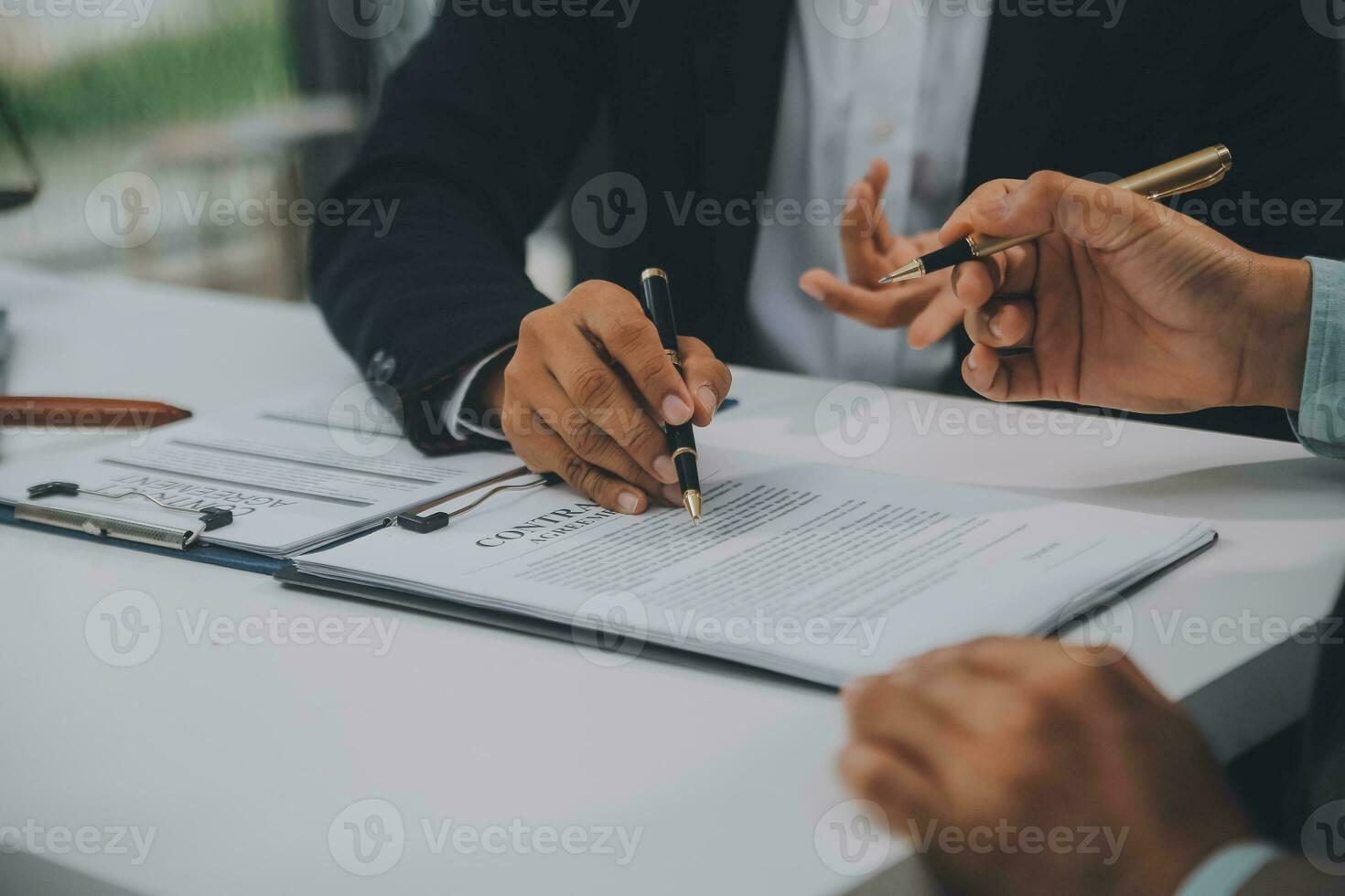 Business and lawyers discussing contract papers with brass scale on desk in office. Law, legal services, advice, justice and law concept picture with film grain effect photo