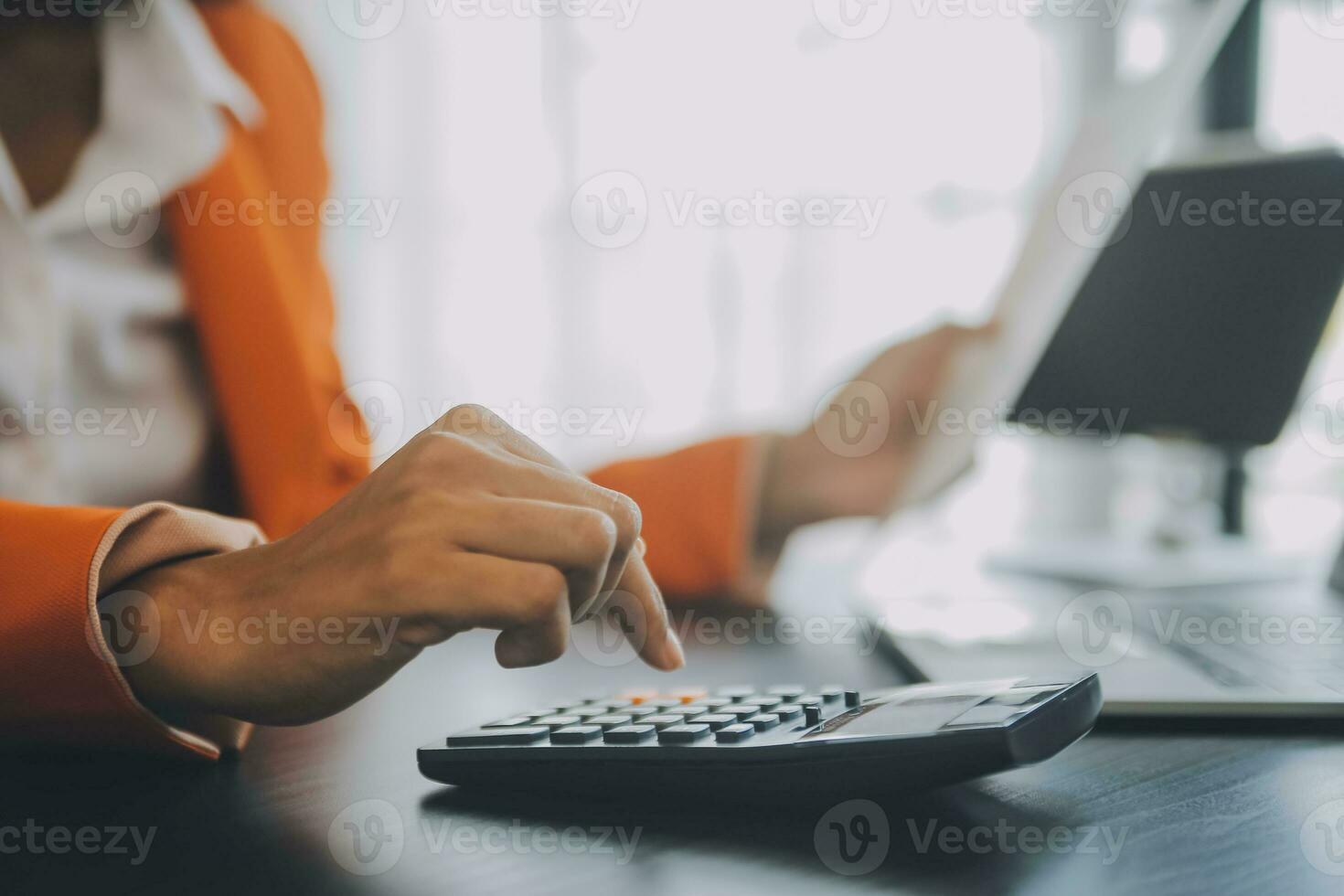 Close up Business man using calculator and laptop for do math finance on wooden desk, tax, accounting, statistics and analytical research concept photo