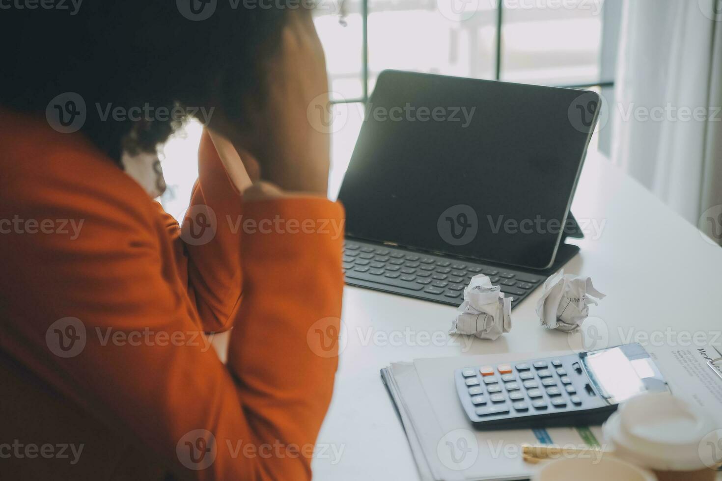 Portrait of tired young business Asian woman work with documents tax laptop computer in office. Sad, unhappy, Worried, Depression, or employee life stress concept photo