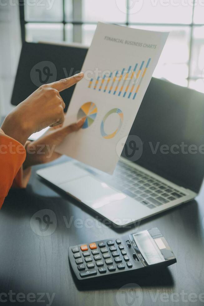 Close up Business man using calculator and laptop for do math finance on wooden desk, tax, accounting, statistics and analytical research concept photo