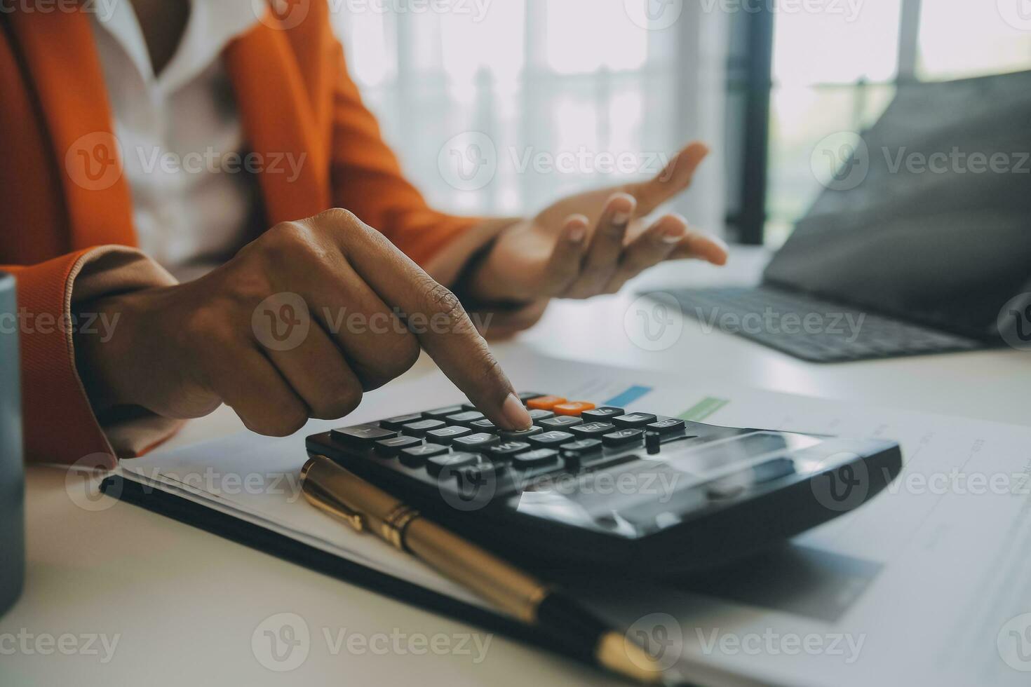 Close up Business man using calculator and laptop for do math finance on wooden desk, tax, accounting, statistics and analytical research concept photo