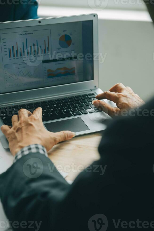 Financial analysts analyze business financial reports on a digital tablet planning investment project during a discussion at a meeting of corporate showing the results of their successful teamwork. photo