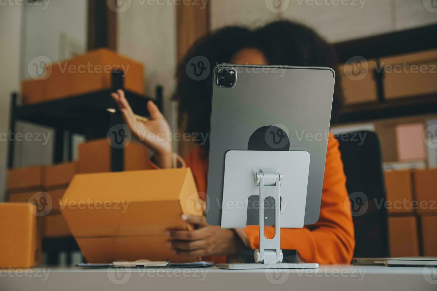 Startup SME small business entrepreneur of freelance Asian woman using a laptop with box Cheerful success happy Asian woman her hand lifts up online marketing packaging and delivery SME idea concept photo