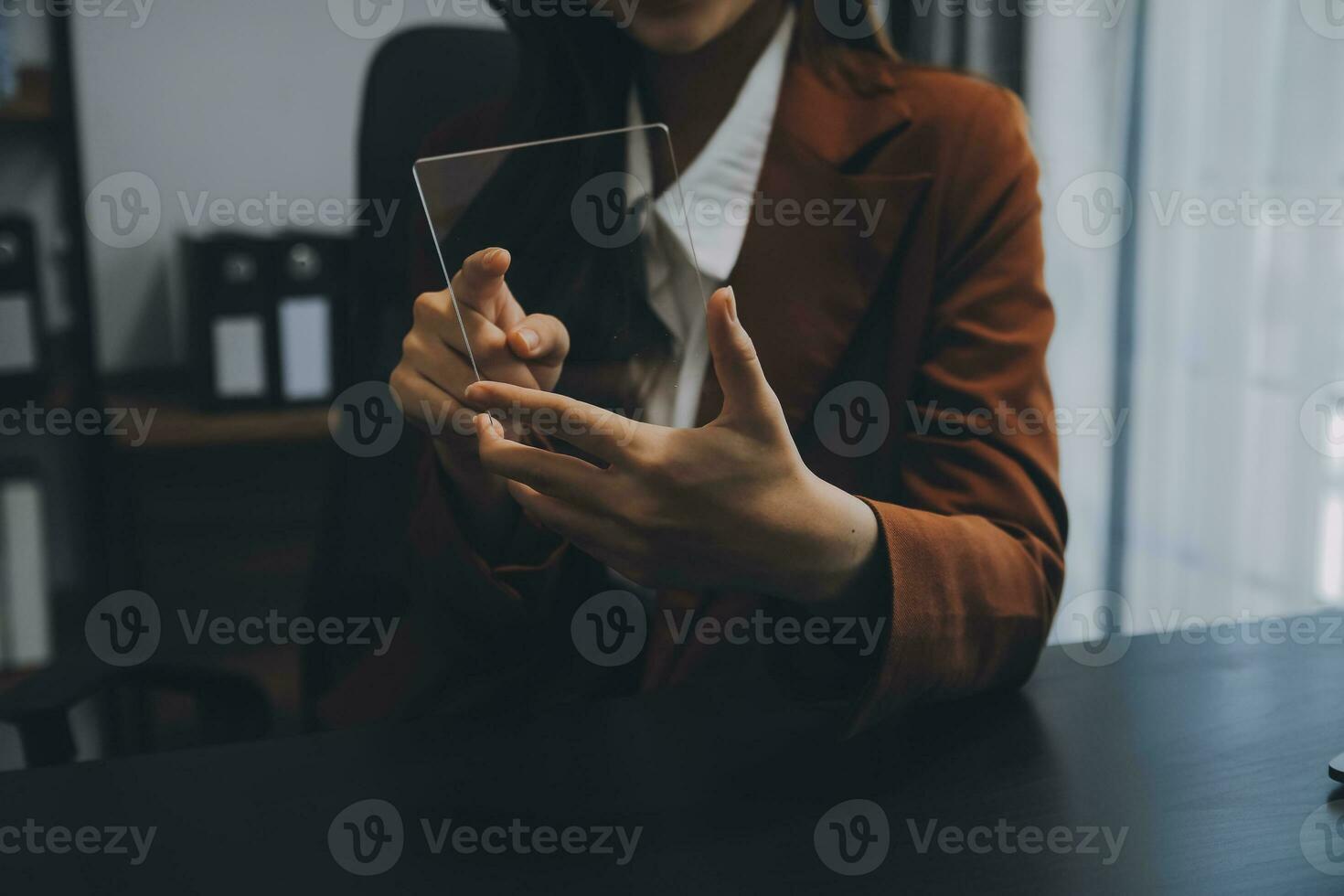 Asian Businesswoman Using laptop computer and working at office with calculator document on desk, doing planning analyzing the financial report, business plan investment, finance analysis concept. photo