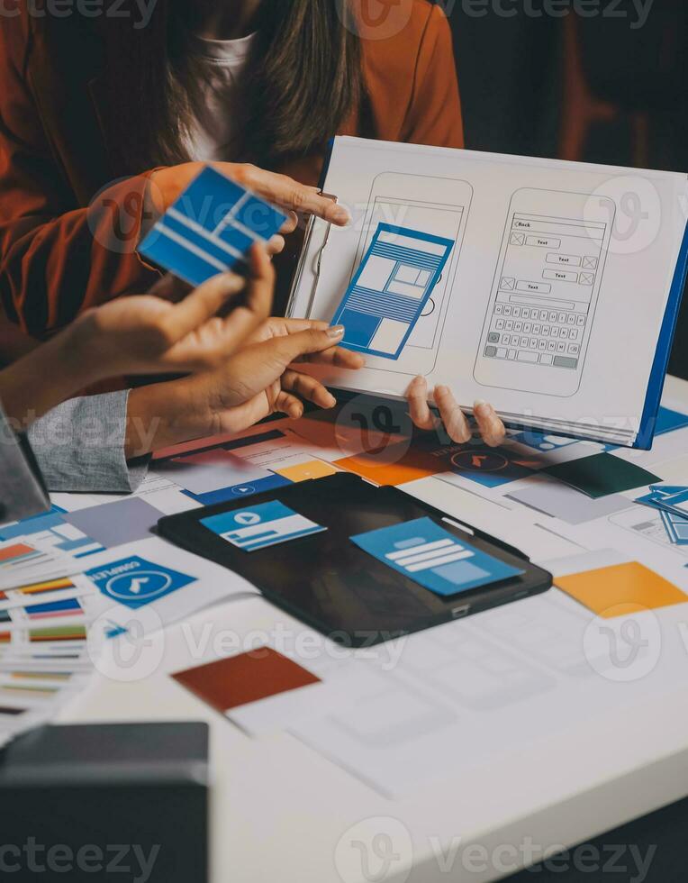 team of UI UX web designer are working together to develop mobile responsive websites. Mobile Mockup photo