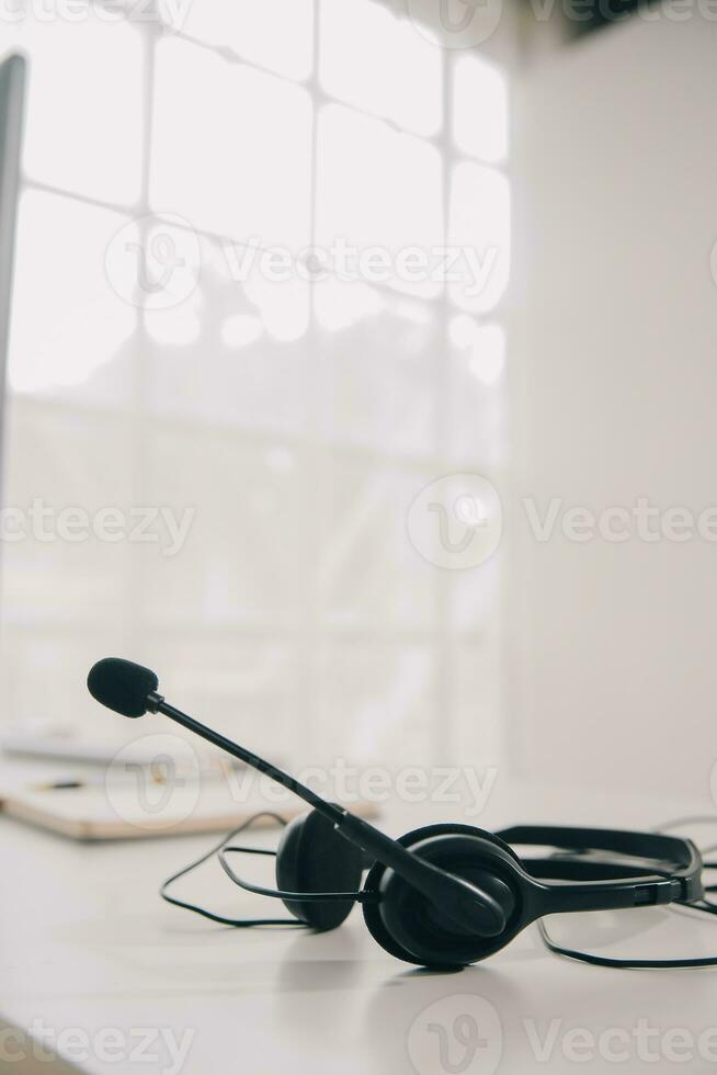 Communication support, call center and customer service help desk. VOIP headset on telephone keyboard. photo