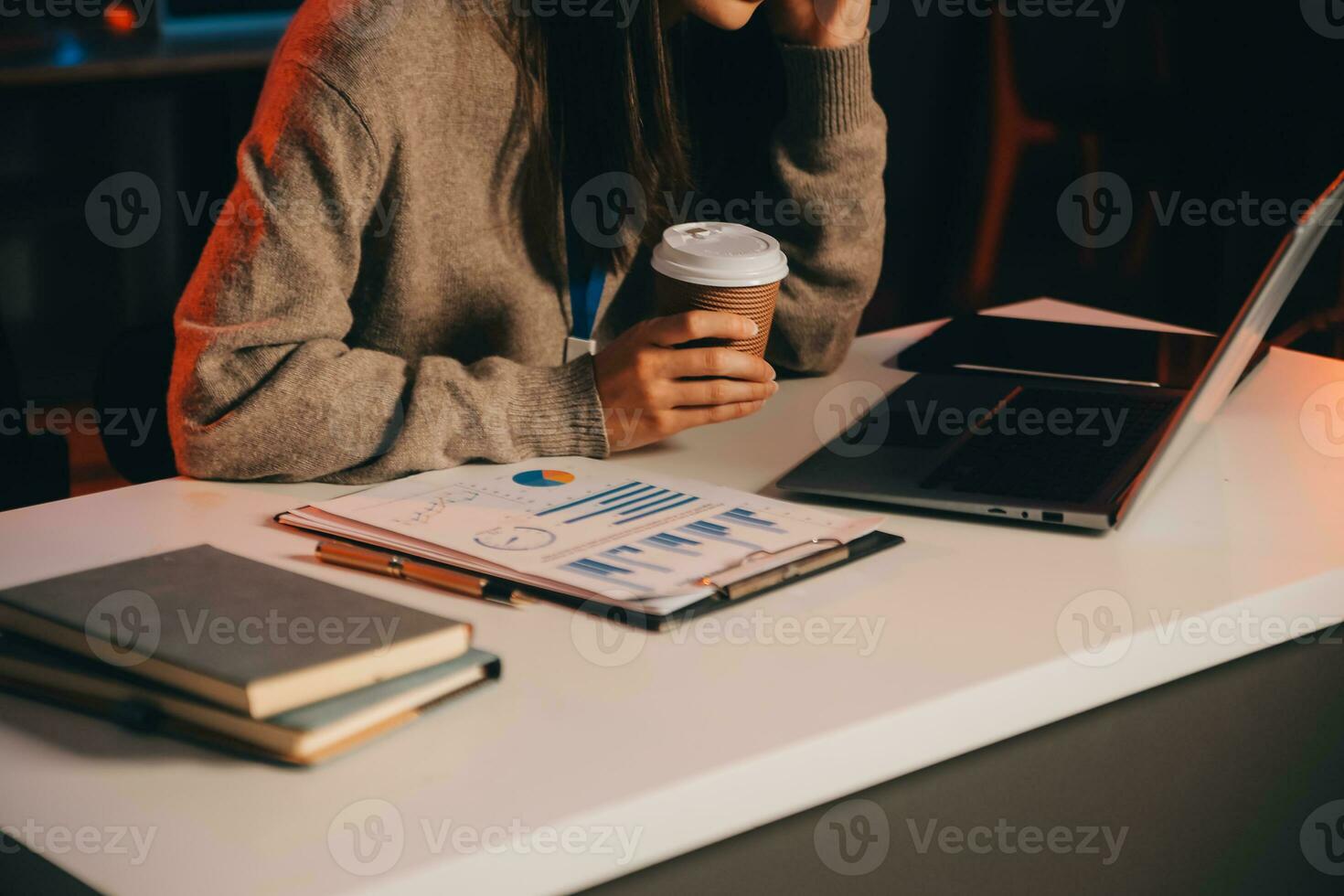 Team of software developers working on big project late at night in neon light trying to finish before deadline photo