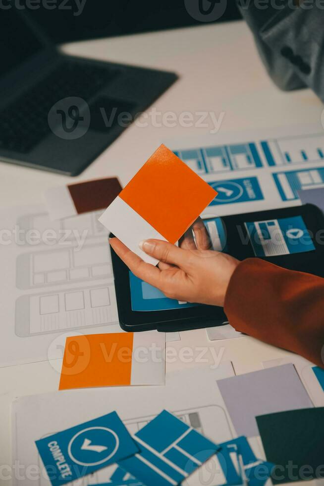 team of UI UX web designer are working together to develop mobile responsive websites. Mobile Mockup photo